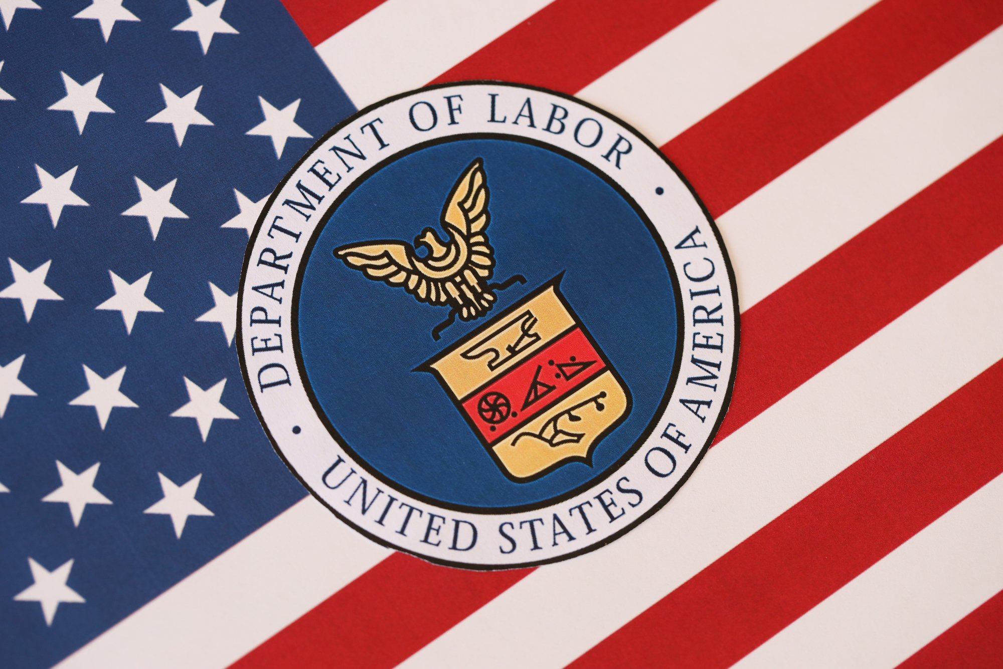 US Department of Labor seal on United States of America flag close up